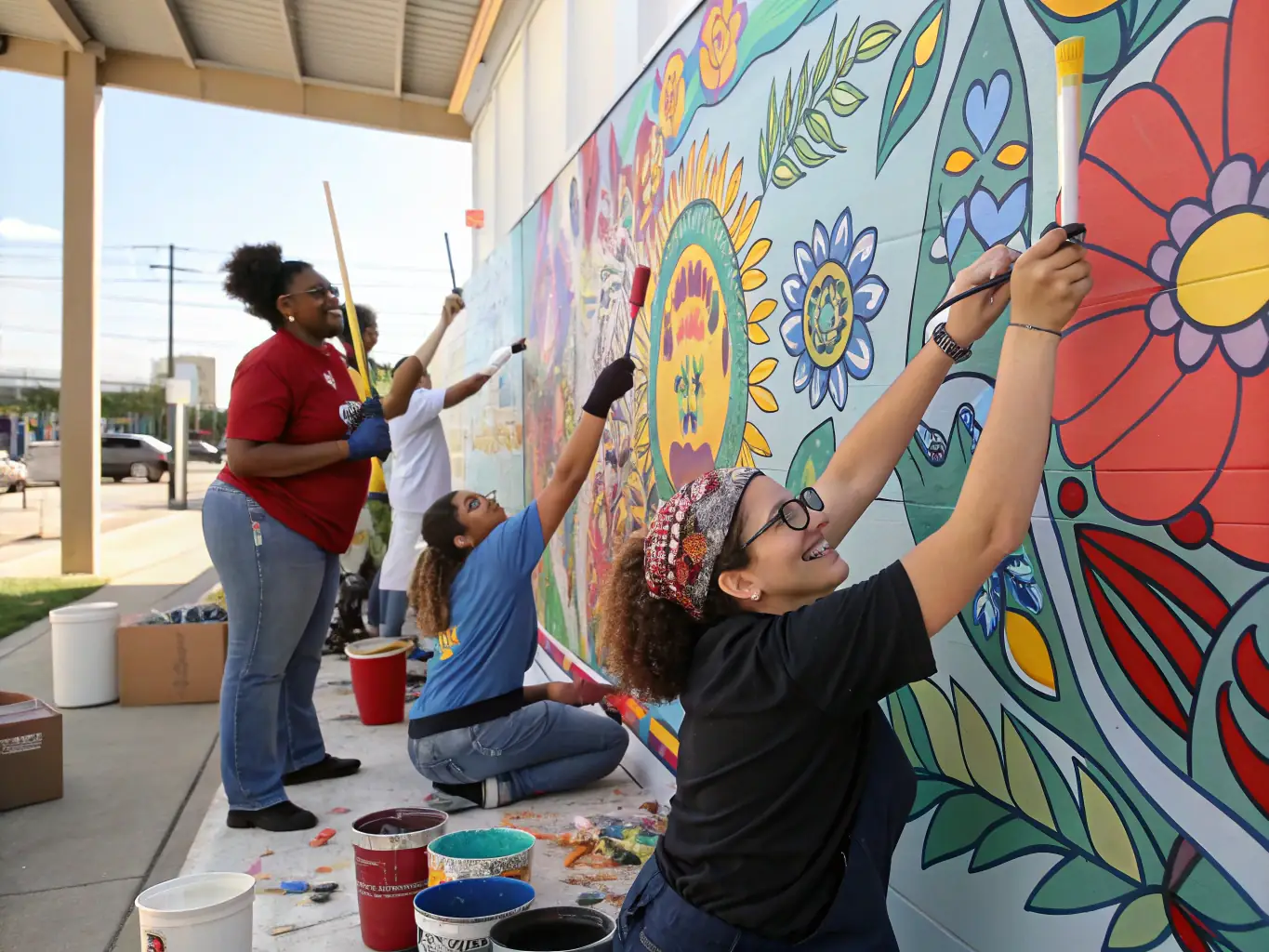 A dynamic image of a collaborative art project in progress, with community members working together to create a mural that reflects the cultural identity of Central Brittany.